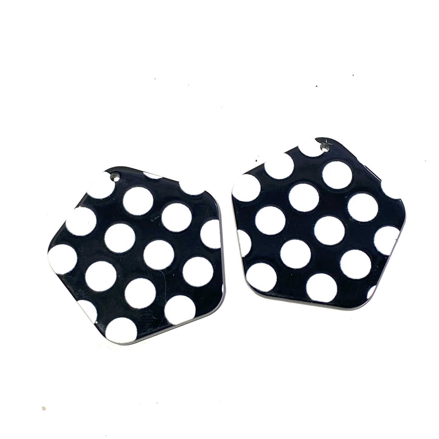 Black charms with white dots