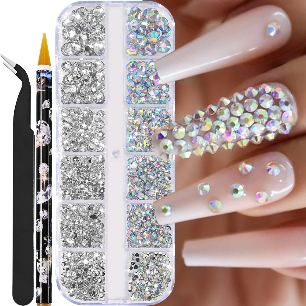 Låda med små pearls eller strass stenar med verktyg