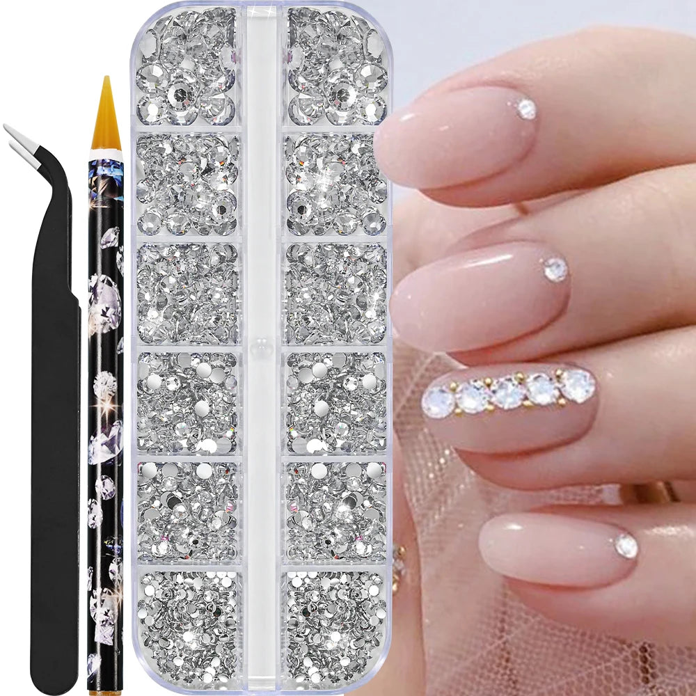 Låda med små pearls eller strass stenar med verktyg