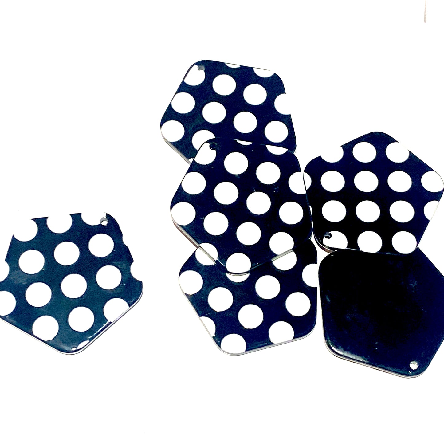Black charms with white dots