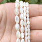 White oval shell beads in various sizes