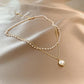 Dubbel halsband 18k guld med vita pärlor