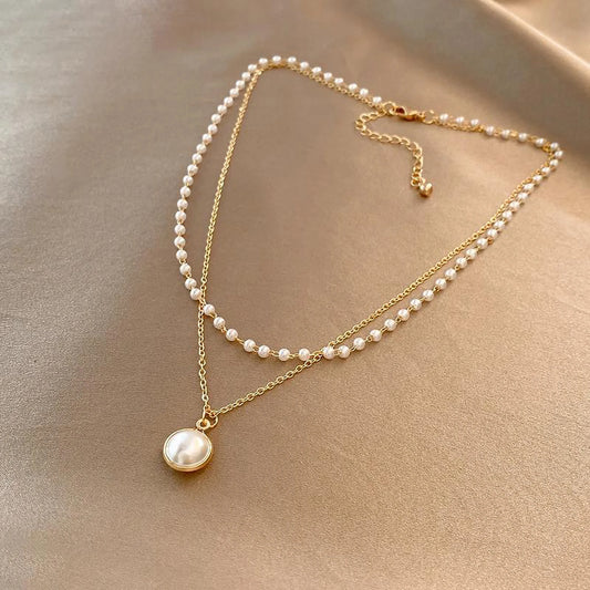 Dubbel halsband 18k guld med vita pärlor